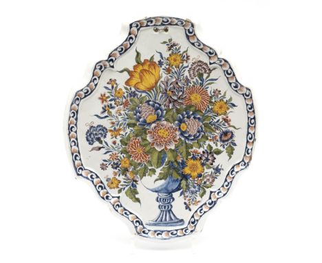 A large Delft polychrome pottery floral wall plaque,Second half 18th century, Netherlands,A shaped oval plaque with a garden 