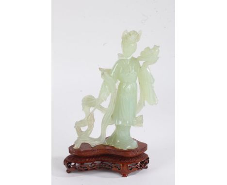 Chinese jade style figure, in the form of a female figure standing holding a tray, on hardwood base, 23cm high