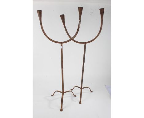 Pair of eastern metal floor standing candelabra, each having twin branches and raised on three feet, each approx. 88.5cm tall