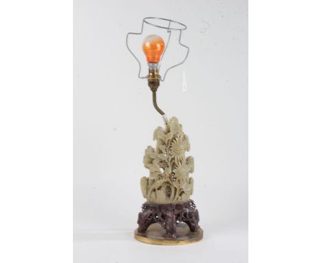 Chinese carved soapstone table lamp, carved with flowers and raised on an oval brass base, 32cm high excluding fitting and sh