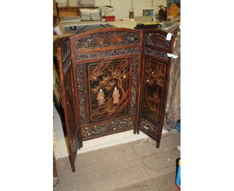 Early 20th century Japanese folding screen, the three part screen having pierced borders centred with lacquered panels and tw