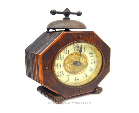 An oak cased alarm clock with Arabic dial.