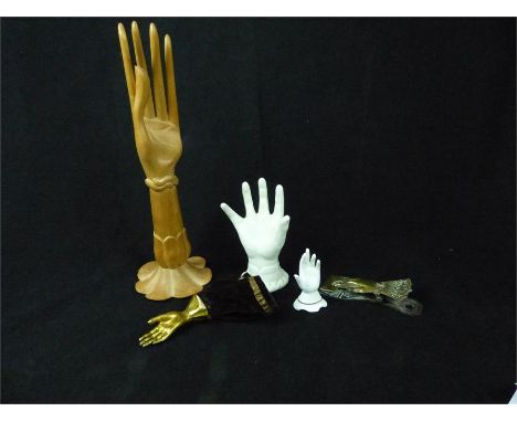 A collection of vintage decorative hands/ ring holders to include a carved wooden oriental example, a Victorian white glass h