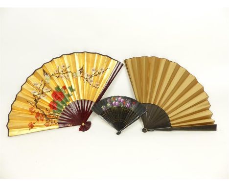 Three vintage fans to include a large, 19th century Japanese gentleman's court fan in gold silk and black lacquered wood, a c