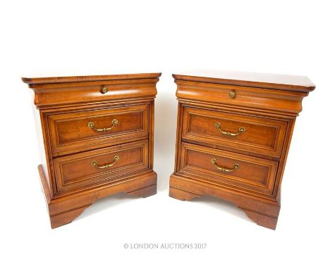 A pair of Continental cherrywood bedside chests having three drawers, raised on shaped bracket supports, 69 x 61 x 43cm