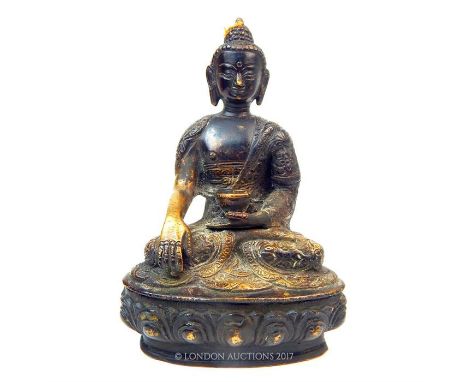 A gilt Bronze Buddha, seated holding a cup; 19.5cm high.