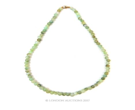 A Chinese green jade beaded necklace with 9 ct yellow gold clasp, composed of eighty-two circular green jade beads (varying h