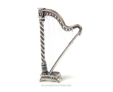 A cast silver miniature harp; 6cm high.