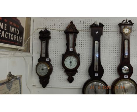 A carved oak barometer