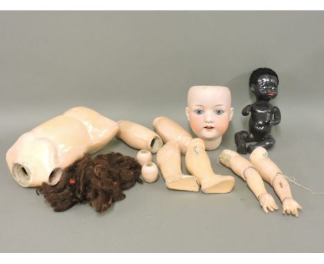 A 'Heubach' bisque head doll, in parts, a black doll, another, and a stationary steam engine