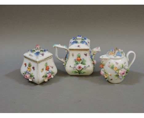 A Dresden miniature teapot and cover, sucrier and cover, and milk jug and cover, with applied flowers, pot 9cm high