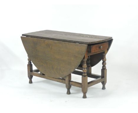 An antique oak gate leg table