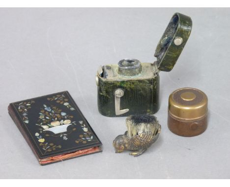 Two Victorian travelling inkwells, a brush wipe in the form of a chick, a Victorian papier mâché notebook with mother of pear