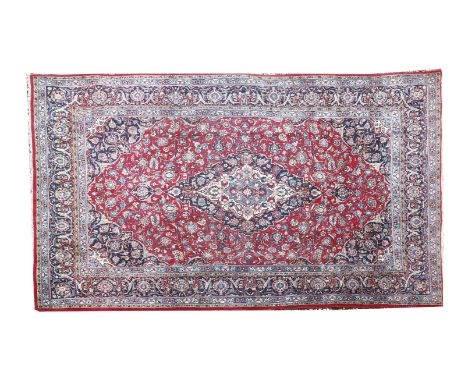 A Persian carpet, with central diamond medallion, 217 x 323cm