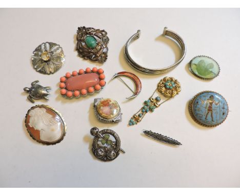 Assorted brooches, a sterling silver torque bangle set with a diamond, and assorted silver rings