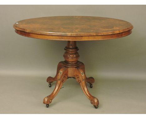 A Victorian oval shaped walnut tilt top table, on a pedestal base