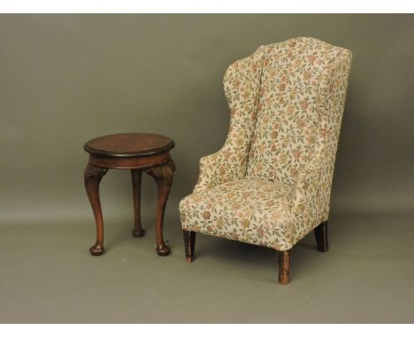 A child's small upholstered wing bedroom chair, and a circular walnut occasional table