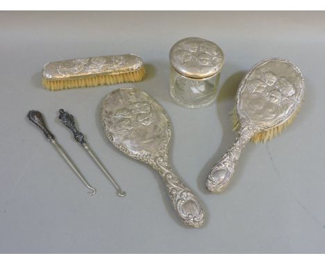 A silver backed matched dressing table set, to include hair brush, mirror and clothes brush, a vanity pot, and two silver han