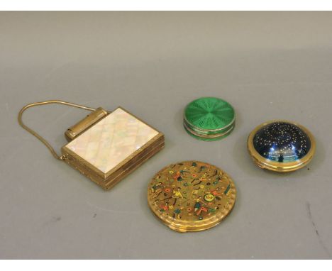 Four ladies compacts, a silver and enamel example, a Kigu 'Flying Saucer', a Kigu 'Rock n' Roll gilt metal example, and a mot