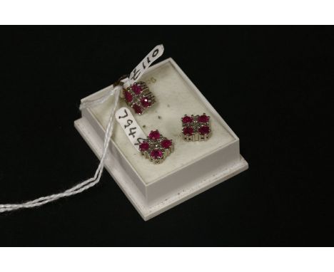 A 9ct gold diamond and ruby pendant and earring suite