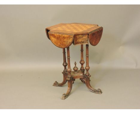 A Victorian walnut centre table, the shaped drop leaf top with chequer board inlay, and two corner drawers, and bone chess pi