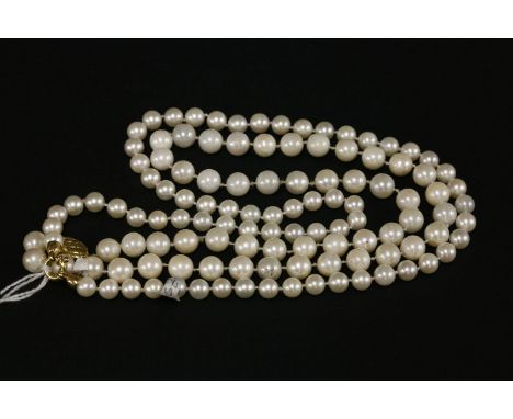 A single row cultured pearl necklace, with a safety clasp stamped 375, together with a single row uniform cultured pearl neck