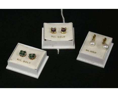 A pair of 9ct gold diamond and emerald cluster earrings, a pair of 9ct gold amethyst and diamond stud earrings, and a pair of