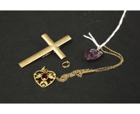 A Victorian gold cross, tested as approximately 15ct gold, an Edwardian garnet and split pearl heart shaped gold pendant test
