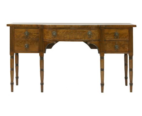 A George III mahogany sideboard, the breakfront with a central drawer flanking drawers and a cupboard, on ring turned support