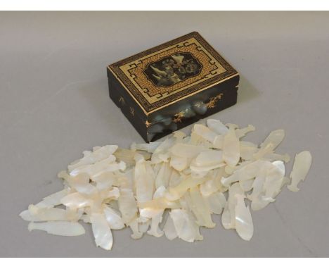 A Chinese lacquer box, containing a large quantity of mother of pearl fish gaming counters
