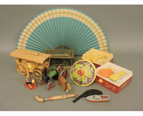 A box of various old toys, including a Japanese tin toy mechanical giraffe, top, Mamod steam engine, etc