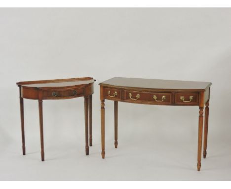 A reproduction bow fronted side table, with three drawers on reeded legs, 103 x 52 x 77cm, and a reproduction side table, 82 