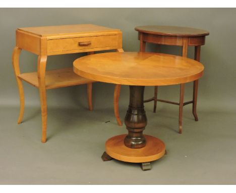 A Swedish birchwood circular coffee table, a two tier table with a drawer, and an oval lamp table