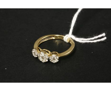 An 18ct gold diamond set triple cluster ring