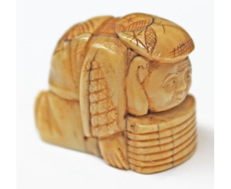 A 19th Century Japanese ivory netsuke formed as a figure kneeling, two character signature to base, length 3.3cm. CONDITION R