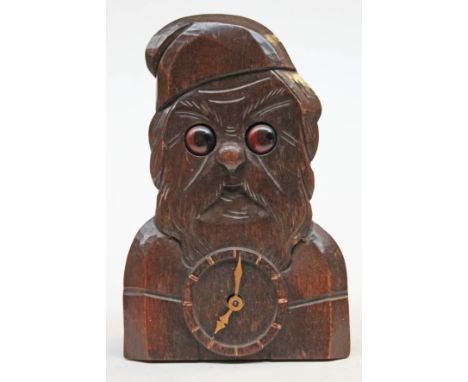 A German vintage carved wooden clock formed as Father Christmas with revolving eyes, height 20cm. CONDITION REPORT - ticking 