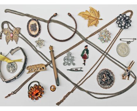 A mixed lot to include two guard chains, a 'Scotsman' enamel brooch, an enamel brooch formed as a Viking boat, a gold plated 