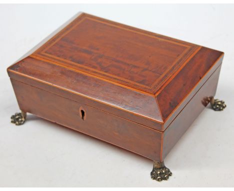 A Regency inlaid walnut tea caddy on four claw feet, length 22cm. CONDITION REPORT - old hairline to top, small chip to escut