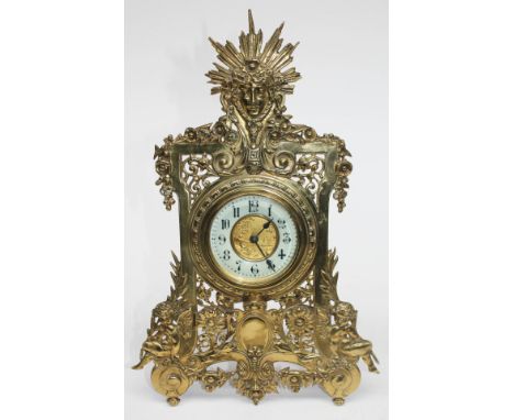 A late 19th Century pierced brass clock having enamel dial with Arabic numerals, height 37cm. CONDITION REPORT - general wear