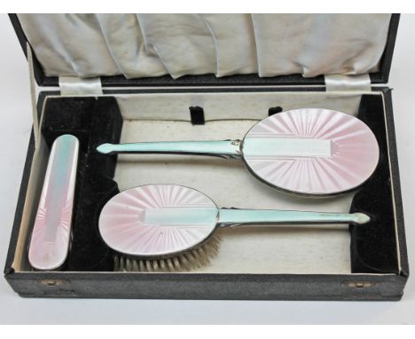 An Art Deco hallmarked silver and enamel dressing table set.