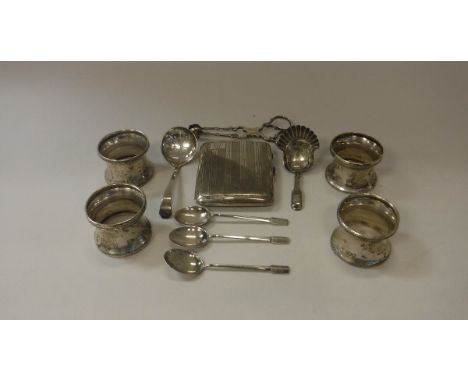 A collection of silver to include a set of four silver knapkin rings by William Comyns, a silver cigarette case with engine t