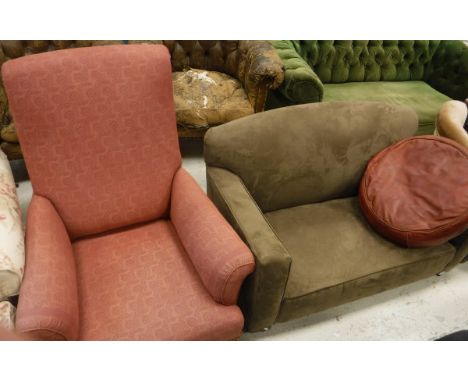 A Victorian upholstered elbow chair raised on turned mahogany front legs to brass caps and casters with self-patterned red up