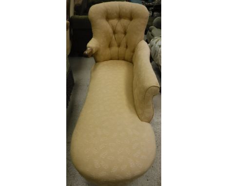 A Victorian button back chaise longue in gold self-patterned upholstery