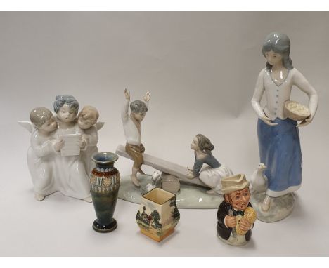 A Lladro figure of three singing angels, a Lladro of boy and girl on a seesaw, a Rex figure goosegirl, Royal Doulton miniatur