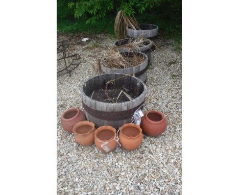 A collection of various terracotta and coopered oak garden pots/urns and four coopered barrel tubs (9)