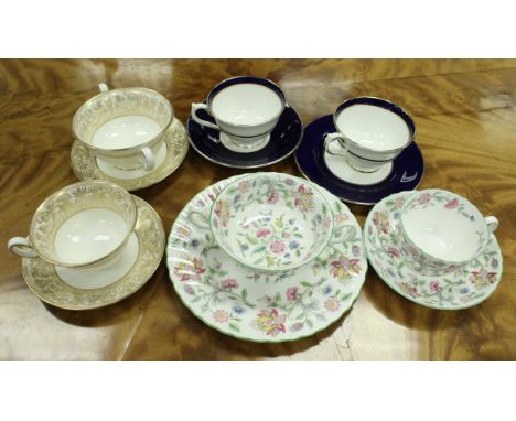 A Minton Haddon Hall bone china part tea service, a Wedgwood gilt decorated bone china tea service and a Grosvenor Henley par
