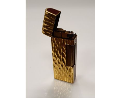 A gold plated Dunhill lighter with bark effect texture