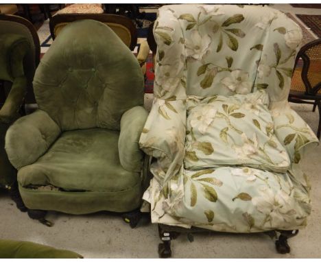 A 19th Century wing back armchair, raised on claw and ball feet, a Victorian shaped button back armchair, raised on carved cu