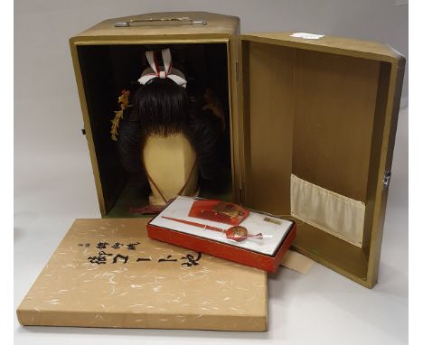 A Japanese Kabuki theatre wig with various adornments in a gold painted case together with two lacquered comb sets and a bolt
