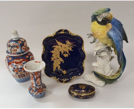 A Karl Ens macaw figure, two Meissen onion pattern leaf dishes, a Royal Worcester figurine "country girl", three pieces of mo